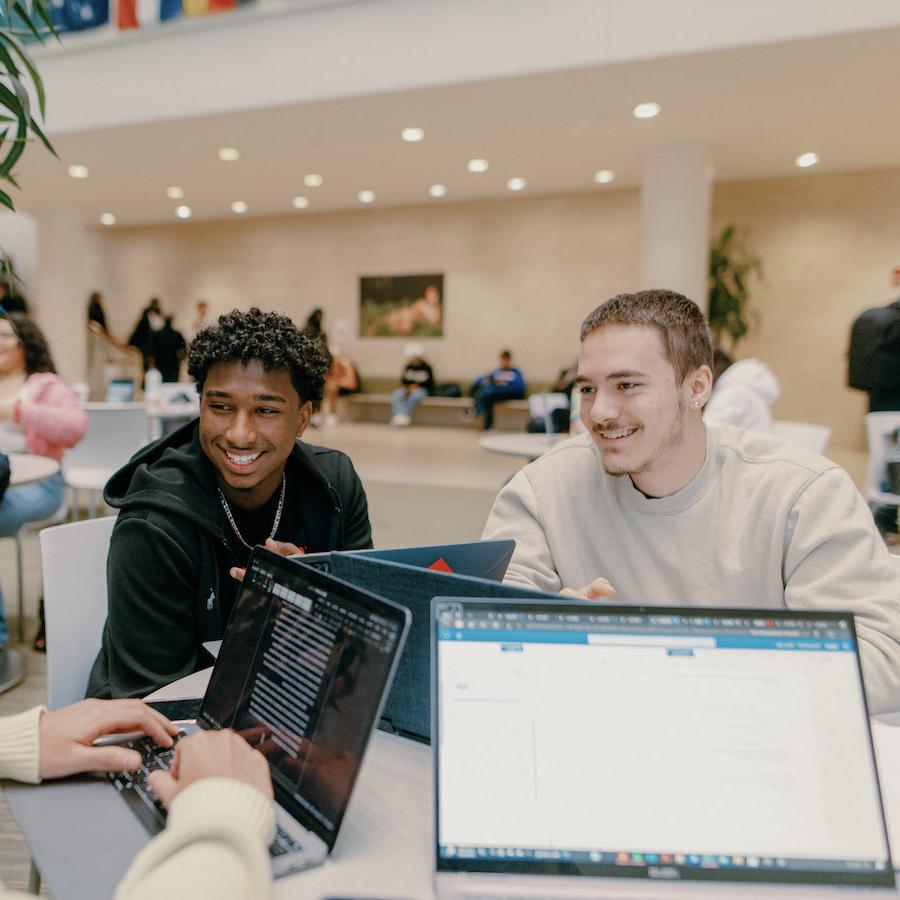 Male students on laptops